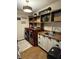 Functional laundry room with wooden countertops, sink, shelving, and red front load washer and dryer at 4414 Hickory Grove Blvd, Greenwood, IN 46143