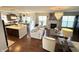 Bright, open living space flows seamlessly into the kitchen, featuring hardwood floors and a charming fireplace at 4414 Hickory Grove Blvd, Greenwood, IN 46143