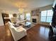 Inviting living room boasts hardwood floors, a stunning chandelier, and a classic fireplace feature at 4414 Hickory Grove Blvd, Greenwood, IN 46143