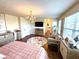 A main bedroom featuring stylish decor, hardwood floors, a crystal chandelier, and ample natural light, creating a cozy atmosphere at 4414 Hickory Grove Blvd, Greenwood, IN 46143