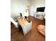 Well-lit office with wood floors, a comfortable chair, and a decorative pouf creates an inviting and functional workspace at 4414 Hickory Grove Blvd, Greenwood, IN 46143