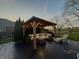 Outdoor patio with covered gazebo with comfortable lounge seating and a nearby hot tub at 4414 Hickory Grove Blvd, Greenwood, IN 46143