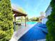 Inviting backyard oasis with pool, hot tub, covered patio, and lush landscaping, perfect for outdoor entertaining at 4414 Hickory Grove Blvd, Greenwood, IN 46143