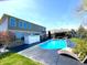 Backyard pool with lounge chairs and white privacy fence, and a covered patio at 4414 Hickory Grove Blvd, Greenwood, IN 46143