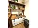 The laundry room's sink has shaker-style cabinets, dark hardware, a wood countertop, and a chrome faucet at 4414 Hickory Grove Blvd, Greenwood, IN 46143