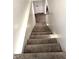 Carpeted staircase featuring neutral colors and providing access to upper or lower levels at 4414 Hickory Grove Blvd, Greenwood, IN 46143