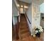 Wood stairway featuring a wooden railing and artwork adding a touch of elegance and charm to the home's interior at 4414 Hickory Grove Blvd, Greenwood, IN 46143