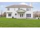 Expansive backyard view of a two-story home with large windows and green lawn at 443 Quincy Pl, Westfield, IN 46074
