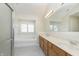 Bright bathroom featuring a double sink vanity, soaking tub beneath a window, and tiled flooring at 443 Quincy Pl, Westfield, IN 46074