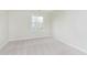 Neutral bedroom with light carpet and a window overlooking landscaping at 443 Quincy Pl, Westfield, IN 46074