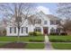 Charming two-story home with painted brick, manicured lawn, and a vibrant red front door at 443 Quincy Pl, Westfield, IN 46074