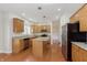 Open kitchen boasts granite counters, an island, stainless appliances, and wood floors at 443 Quincy Pl, Westfield, IN 46074