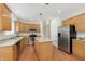 Updated kitchen with stainless steel appliances, granite countertops, island, and wood cabinets at 443 Quincy Pl, Westfield, IN 46074
