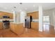 Spacious kitchen with granite counters, wood cabinets, stainless appliances, and hardwood floors at 443 Quincy Pl, Westfield, IN 46074