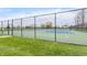 Well-maintained tennis court with vibrant blue and green surface, surrounded by a secure fence at 443 Quincy Pl, Westfield, IN 46074