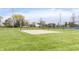 Outdoor sand volleyball court next to a tennis court on a green lawn for recreational activities at 443 Quincy Pl, Westfield, IN 46074