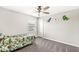 Cozy bedroom features a ceiling fan, neutral paint, and playful dinosaur decor at 474 Pekin Way, Pendleton, IN 46064