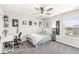 Well-lit bedroom with ceiling fan and window, complete with a desk, providing a comfortable and functional living space at 474 Pekin Way, Pendleton, IN 46064
