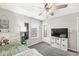 Well-lit bedroom features a ceiling fan, window, and TV, creating a comfortable and functional space at 474 Pekin Way, Pendleton, IN 46064