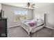 Well-lit bedroom features a ceiling fan and a large window, creating a comfortable and inviting space at 474 Pekin Way, Pendleton, IN 46064