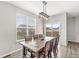 Bright dining room features a wooden table, stylish light fixture, and sliding glass doors to the backyard at 474 Pekin Way, Pendleton, IN 46064