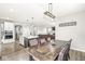Open concept view of kitchen and dining area boasts modern lighting, stainless appliances, and rustic dining table at 474 Pekin Way, Pendleton, IN 46064
