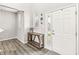 Welcoming entryway with wood flooring and a console table, leading to a bright white front door at 474 Pekin Way, Pendleton, IN 46064