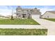 Beautifully landscaped front yard showcases this lovely two-story home, complete with a cozy front porch at 474 Pekin Way, Pendleton, IN 46064