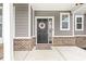 Welcoming front door with stylish wreath, complemented by charming brickwork and cozy porch decor at 474 Pekin Way, Pendleton, IN 46064