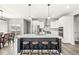 Modern kitchen features a large island with seating, stainless steel appliances, and sleek white cabinetry at 474 Pekin Way, Pendleton, IN 46064