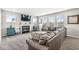 Comfortable living room boasts a fireplace, large windows, and plush seating for relaxation and entertainment at 474 Pekin Way, Pendleton, IN 46064