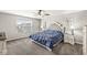 Elegant main bedroom with a tufted headboard, ceiling fan and soft, natural light at 474 Pekin Way, Pendleton, IN 46064