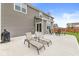 Spacious backyard patio with lounge chairs perfect for relaxing outdoors and enjoying the manicured lawn at 474 Pekin Way, Pendleton, IN 46064