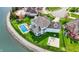 Wide aerial view of a lakeside neighborhood featuring landscaped lawns, mature trees, and beautiful homes at 4883 Snowberry Bay Ct, Carmel, IN 46033