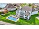 Aerial view of the backyard featuring a pool, basketball court, deck, and landscaped lawn at 4883 Snowberry Bay Ct, Carmel, IN 46033