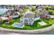 Aerial view of a waterfront home featuring a pool, basketball court, and landscaped lawn at 4883 Snowberry Bay Ct, Carmel, IN 46033