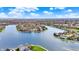 Overhead view displays waterfront homes with lake access, enhanced by beautiful landscaping at 4883 Snowberry Bay Ct, Carmel, IN 46033
