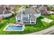 Aerial view of the backyard featuring a pool, basketball court, deck, and landscaped lawn at 4883 Snowberry Bay Ct, Carmel, IN 46033