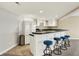 Finished basement bar with white cabinets, dark countertop, and stool seating at 4883 Snowberry Bay Ct, Carmel, IN 46033