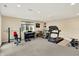 Finished basement gym with weight rack, piano, treadmill, and large window at 4883 Snowberry Bay Ct, Carmel, IN 46033