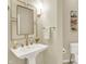 Elegant powder room with a pedestal sink and stylish mirror at 4883 Snowberry Bay Ct, Carmel, IN 46033