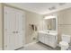 Neutral-toned bathroom with white vanity, mirror, tile floor, and a linen closet at 4883 Snowberry Bay Ct, Carmel, IN 46033