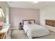 Bedroom featuring a pastel pink accent wall with a window, and a white door to the side at 4883 Snowberry Bay Ct, Carmel, IN 46033