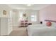 Bedroom with pink accent wall, large white dresser and decorative shelving unit at 4883 Snowberry Bay Ct, Carmel, IN 46033