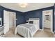 Bedroom with blue walls, white trim, and a bed, as well as an attached bath and walk-in closet at 4883 Snowberry Bay Ct, Carmel, IN 46033