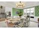 Elegant dining room with green wallpaper, seating for eight, and natural light at 4883 Snowberry Bay Ct, Carmel, IN 46033