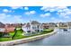 Beautiful waterfront home featuring a pool, deck, and lush green lawn with mature landscaping at 4883 Snowberry Bay Ct, Carmel, IN 46033