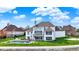 Beautiful backyard featuring a pool, deck, and lush green lawn with mature landscaping and basketball court at 4883 Snowberry Bay Ct, Carmel, IN 46033
