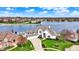Stunning waterfront home boasts lush landscaping, a private pool, and a tranquil lakeside setting at 4883 Snowberry Bay Ct, Carmel, IN 46033