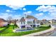 Beautiful waterfront home featuring a pool, deck, and lush green lawn with mature landscaping at 4883 Snowberry Bay Ct, Carmel, IN 46033